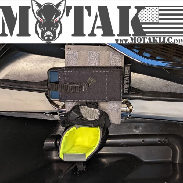 Grey saddlebag organizer panel with a black pouch featuring a neon green interior, secured inside a motorcycle saddlebag with the Motak logo and website URL displayed.