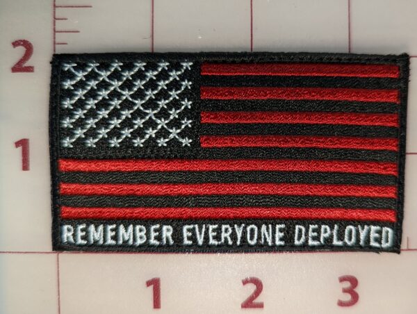 Black and red American flag patch with text "Remember Everyone Deployed."