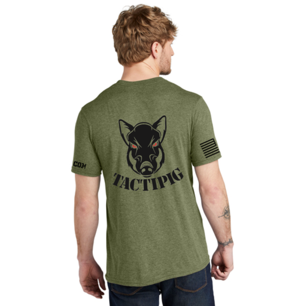 Back view of an olive green Tactipig t-shirt with a black Tactipig logo and text, featuring an American flag design on one sleeve.